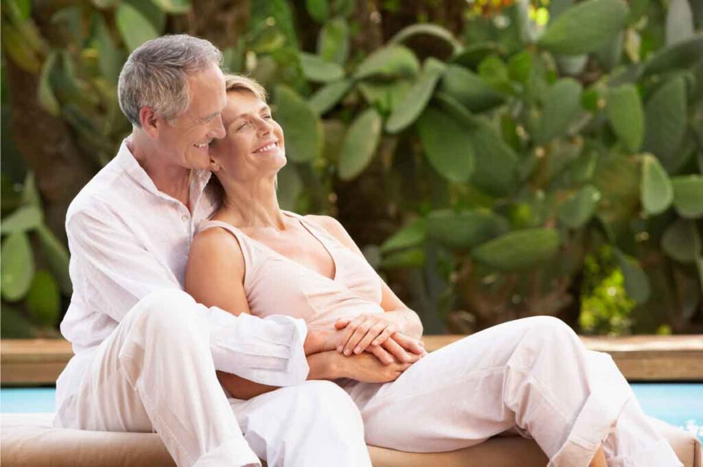 Happy couple embracing outdoors, guided by an ADHD therapist.