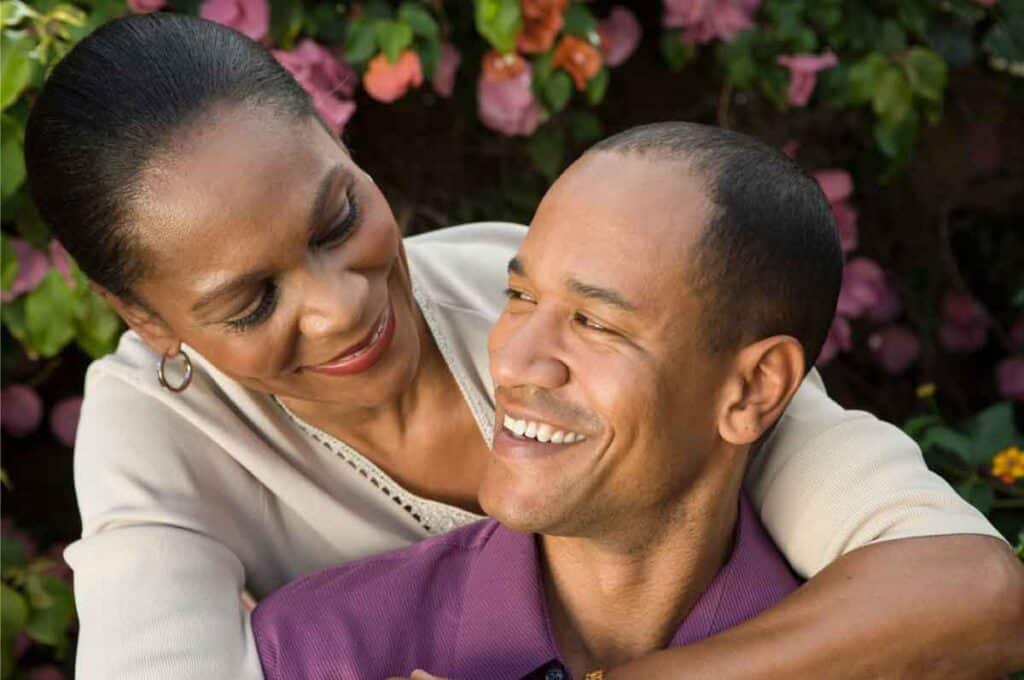 Smiling couple embracing outdoors, finding support through depression counseling together.
