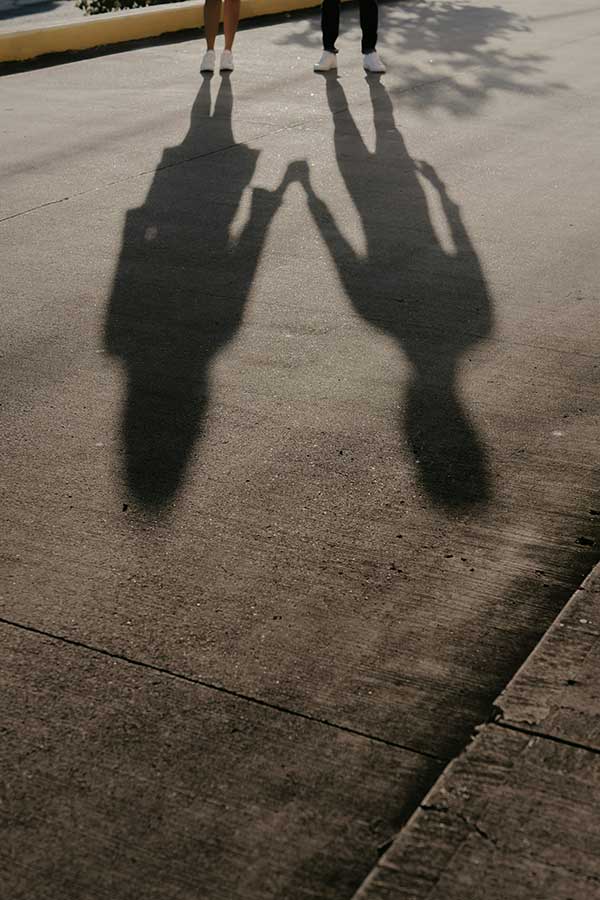 Shadows of a couple holding hands, showing support in addiction therapy in janesville.